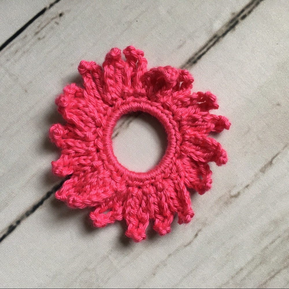 Bright pink crochet flower scrunchie